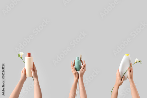 Many female hands with bott...