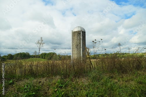 Kentucky rural landscape with farm field and silo in field.