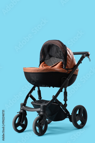 Modern baby stroller on blu...