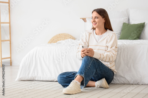 Young woman using mobile ph...