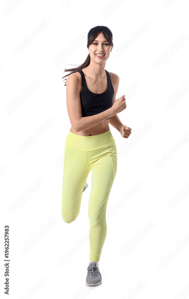 Fototapeta premium Beautiful young happy sporty woman running on white background