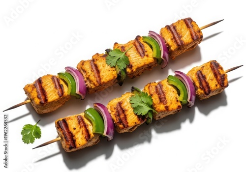 Grilled chicken skewers with vegetables on white background