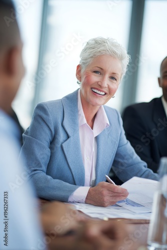 Caucasian woman in business attire smiling during meeting