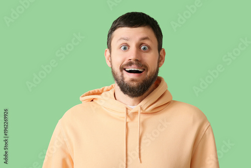 Surprised young man on gree...