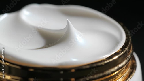 Luxurious white cream swirls with golden accents on a dark background, cosmetic texture, beauty product close up, skincare and self care