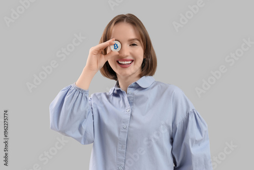 Young woman with bitcoin on...