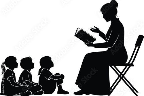 Black silhouette of a female teacher sitting on a chair reading a book to a group of three small children sitting on floor