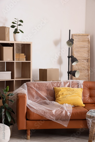 Brown sofa with film and ca...