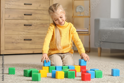 Cute little girl playing wi...