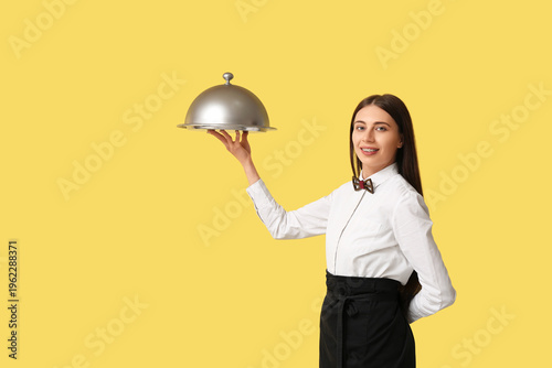 Waitress with silver tray a...