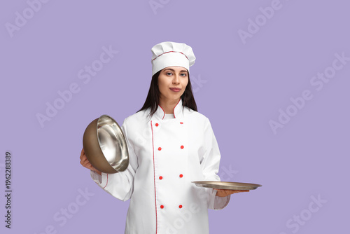 Female chef with metal tray...
