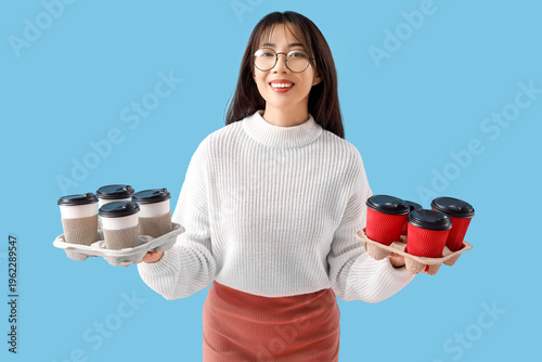 Young Asian woman with cups...