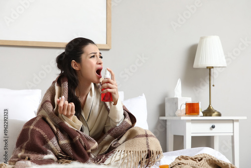 Ill young woman spraying he...