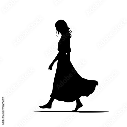 Barefoot woman walking in a long dress with her skirt flowing in the wind