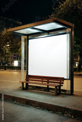 No people, quiet scene, digital display blank, white bench in corner of sidewalk
