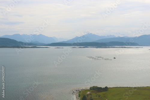 View from plane on mountains, fjord and fish farm, Norway