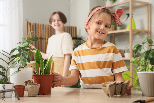 Cute little girl with plant...