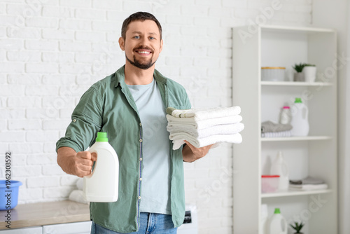 Young man with laundry dete...