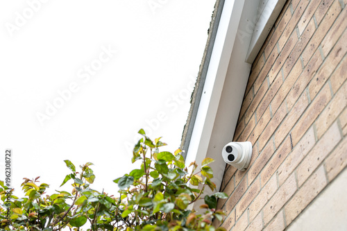 Newly installed, night and day dome CCTV camera installed under plead tic roof eaves of a private house. The CCTV is looking towards the front garden.
