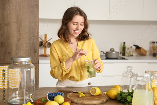 Young woman with tasty lemo...