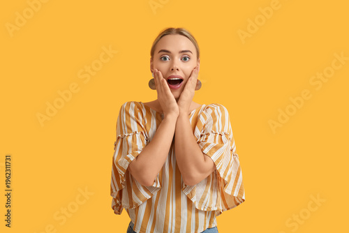 Happy young woman on orange...