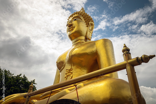Bild auf Leinwand Big golden buddha statue on mountain with cloud in morning Pattaya Thailand