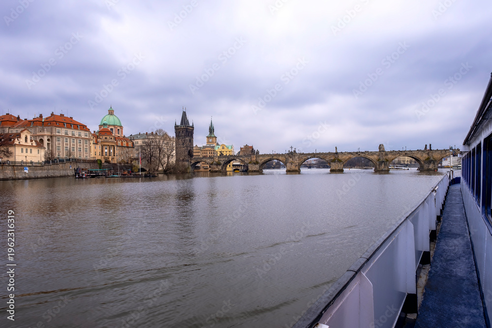 Fototapeta premium View of the Charles Bridge, that cross the Vltava river in the old centre of Prague. Built in the XII century and decorated by several religious statues, it is the most famous bridge of Prague.