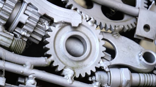 Assembled silver mechanical gears and scrap metal parts in a seamless loop style.