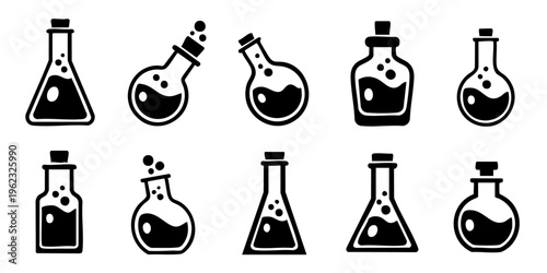 A collection of various laboratory flasks and beakers on a table indoors