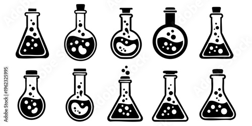 Various laboratory flasks and beakers containing bubbling liquids on a table indoors.