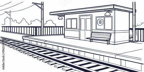 A train station with a small building and a bench