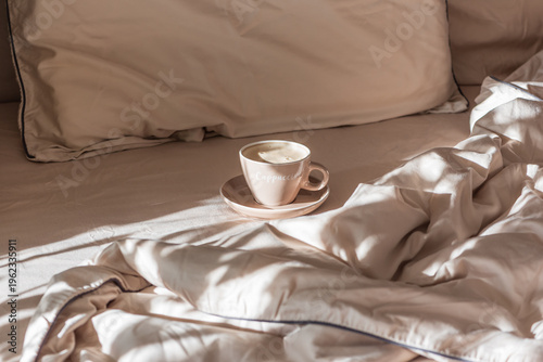 Cappuccino Cup on Cozy Bed with Sunlight
