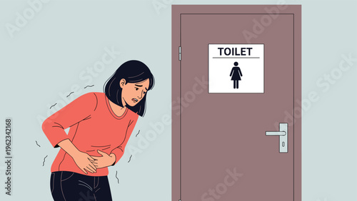 Young woman clutching her stomach in discomfort, standing anxiously in front of a public toilet door, indicating an urgent need or stomach pain.