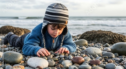 Young Boy Playing with Stones on Beach.