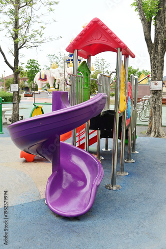 A large outdoor playground for children with a variety of play equipment, which is part of the public park.