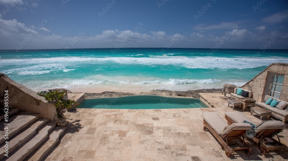 Fototapeta premium Oceanfront luxury residence with pool and lounge chairs on sunny beach