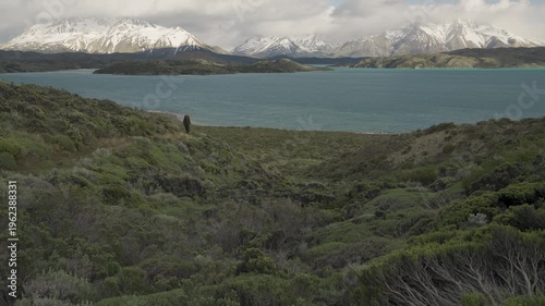 Hiker walking on a trail overlooking Belgrano Lake in Perito Moreno National Park in nature