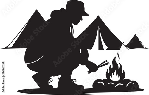 Black silhouette of a person starting a campfire at a campsite with tents