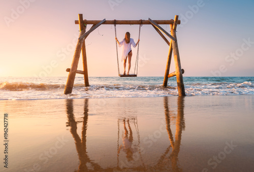 Happy young woman on wooden...