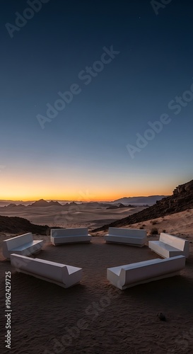 Serene desert landscape at dawn with modern white seating arranged in a circle overlooking misty valleys and distant mountains.