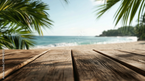 Close-up of wooden surface by the seaside, green palm leaves partially visible in corners, calm waves and beach in background	