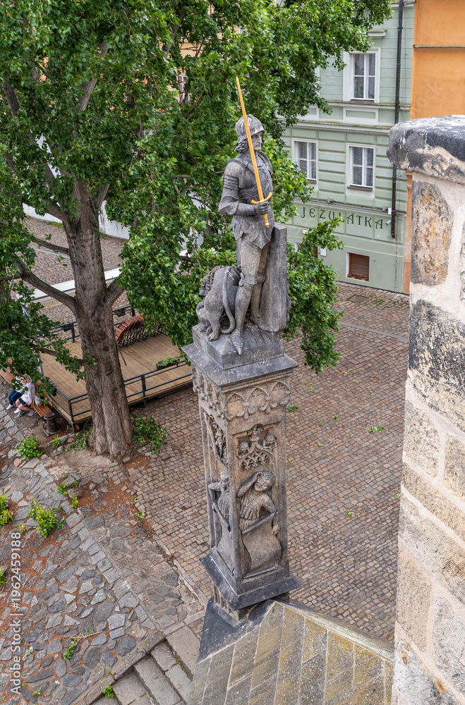 Fototapeta premium Statue of Bruncvík and his Faithful Lion on Charles Bridge in the Prague old city in Czech Republic