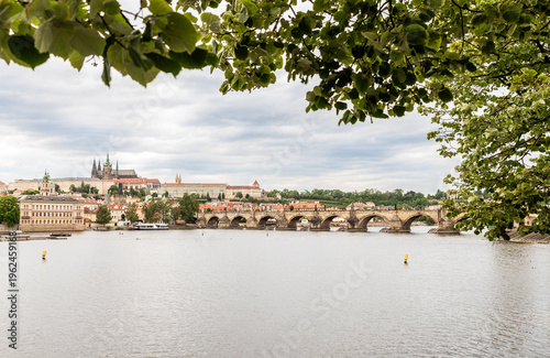 View from Smetano Embankment to the Charles Bridge and ancient buildings on embankment in Prague old city in Czech Republic