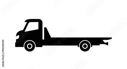 Silhouette of a flatbed tow truck vehicle in black