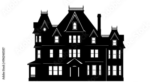 Silhouette of a large victorian style house with multiple peaks and turrets