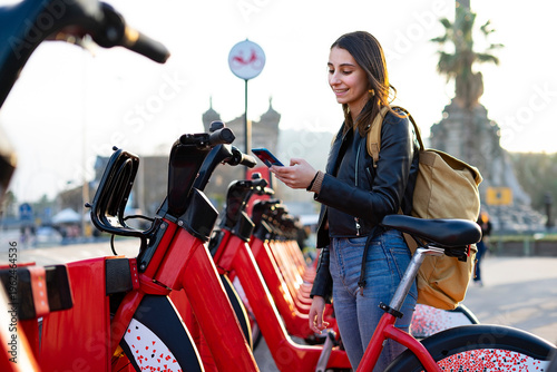 Woman renting a bicycle in the city. Electric bicycles. Rent a bike.