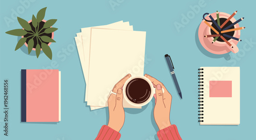 Overhead view of a workspace with hands holding a cup of coffee, papers, a pen, notebooks, and a plant on a blue desk.