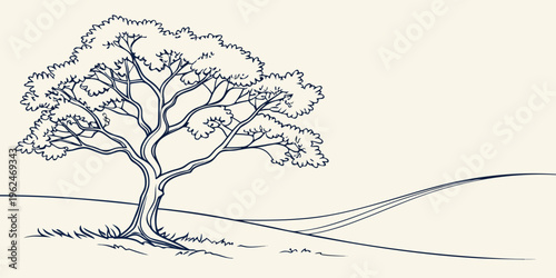 A majestic tree standing tall on a gentle hillside with a clear blue sky