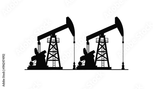 Silhouette of two oil pump jacks in operation at a drilling site