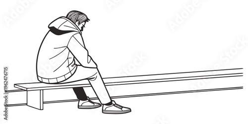 A person sitting alone on a bench in a train station, looking out at the tracks.